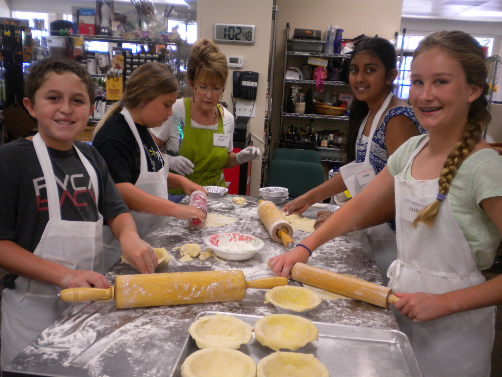 Mary helping  Jamie,Esha & Lily make Pie Crusts